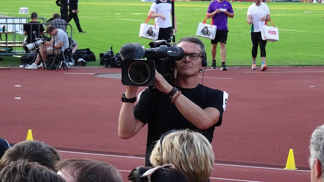 camera operator filming interview desk